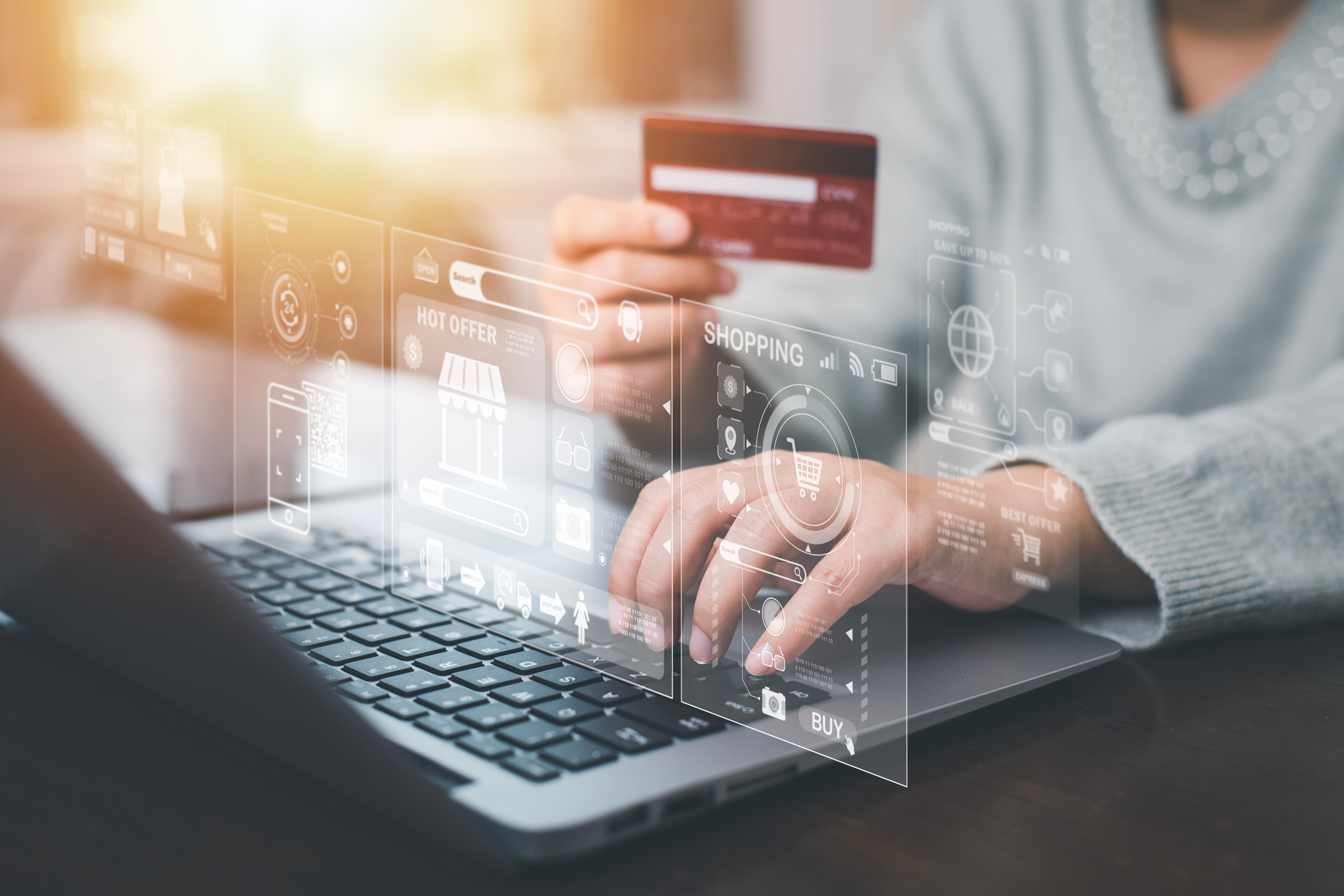 Women use a laptop and hold credit cards for making a purchase o