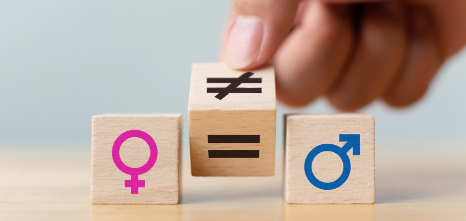 Concepts of gender equality. Hand flip wooden cube with symbol unequal change to equal sign